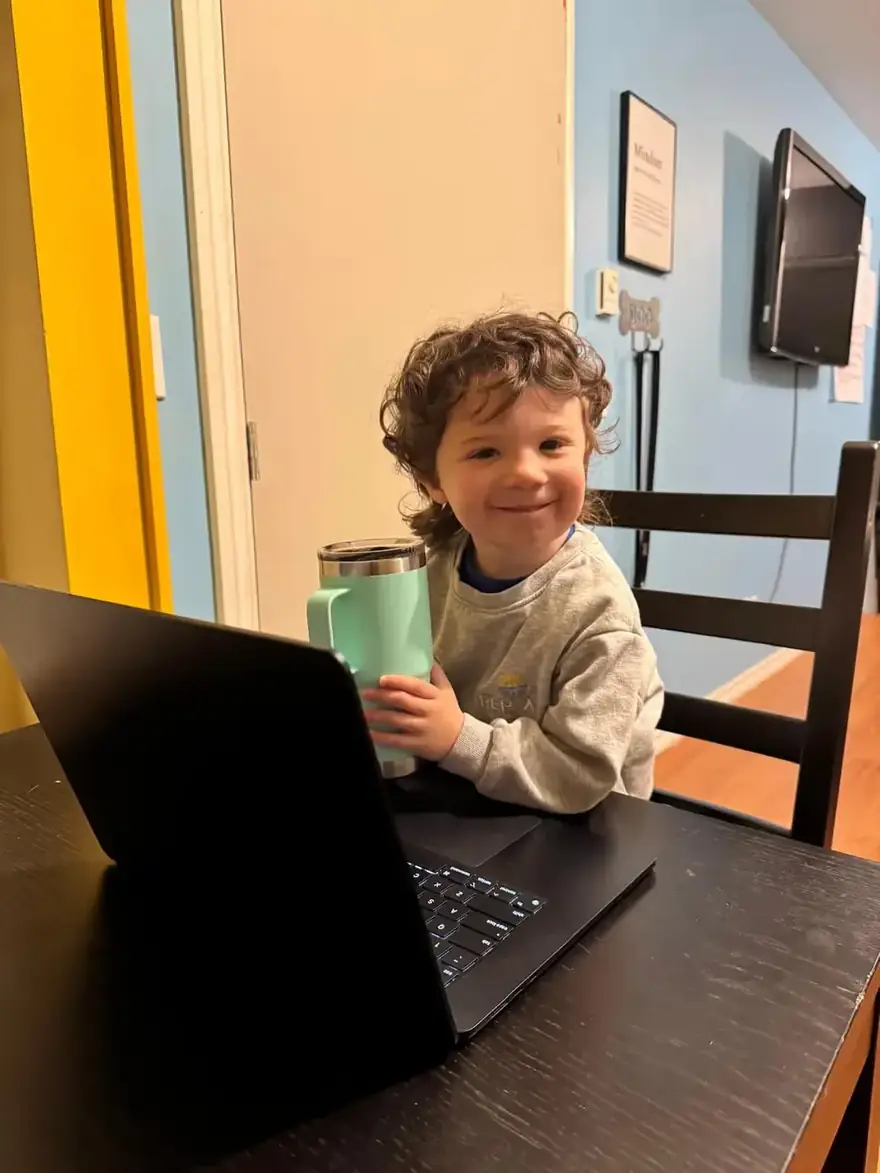 Child with a Rep-Air cup at an office desk