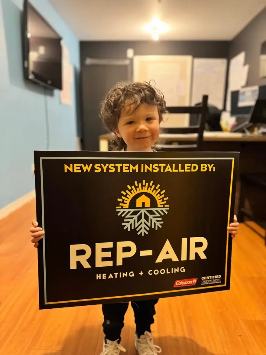 Child holding a New System Installed by Rep-Air sign
