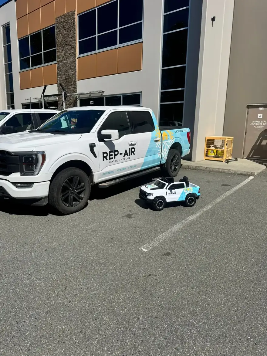 Rep-Air truck and a toy Rep-Air truck in the shop parking lot