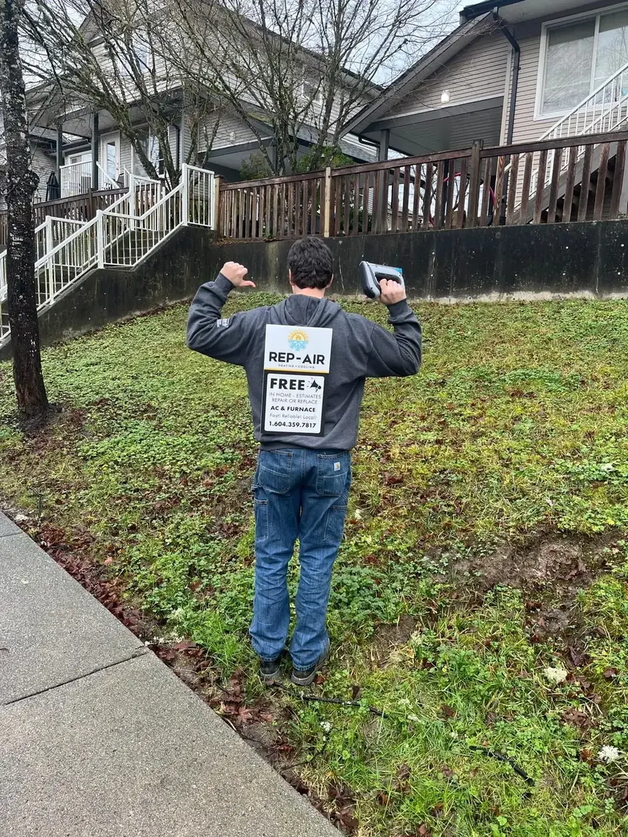 Person wearing a Rep-Air sign on a front lawn
