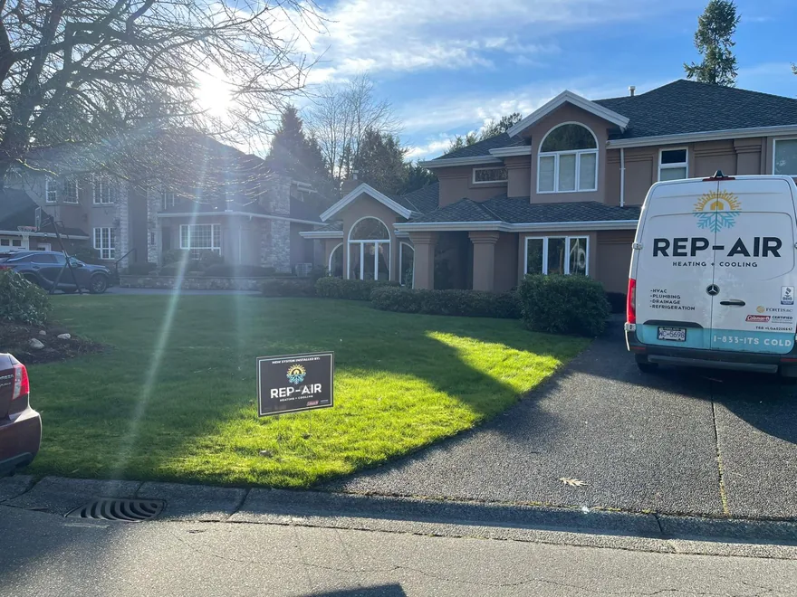 Rep-Air van and yard sign at a home
