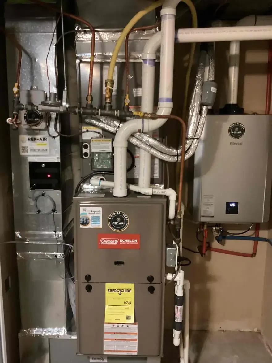 Coleman gas furnace beside a tankless water heater in a utility room