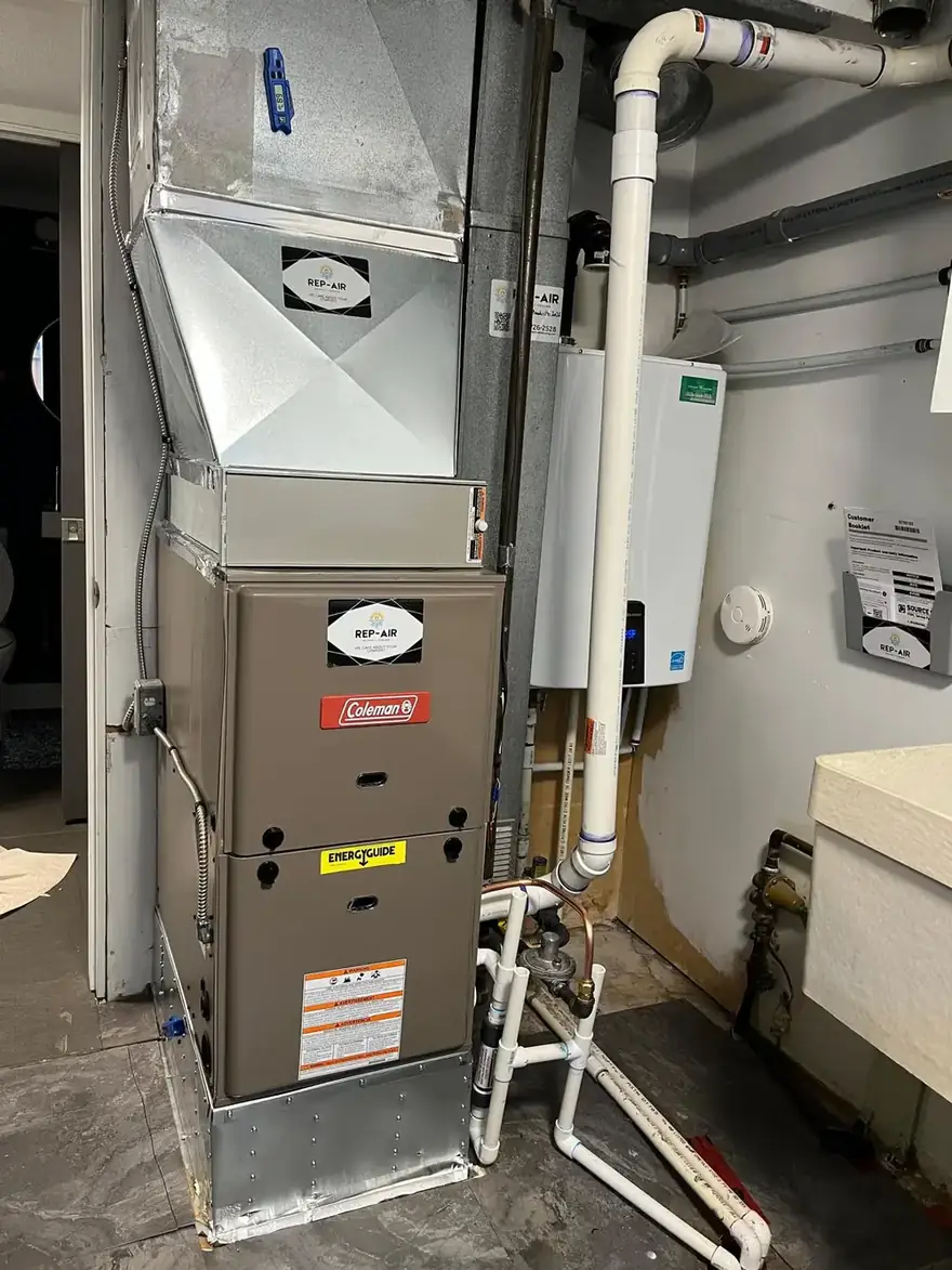Coleman gas furnace and new ductwork in a utility room
