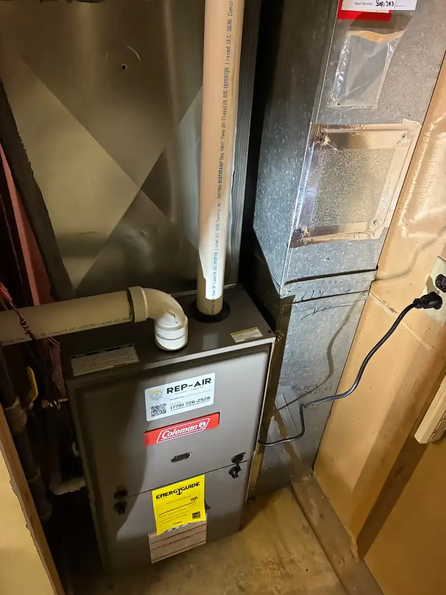 Coleman gas furnace with a Rep-Air service sticker in a basement closet