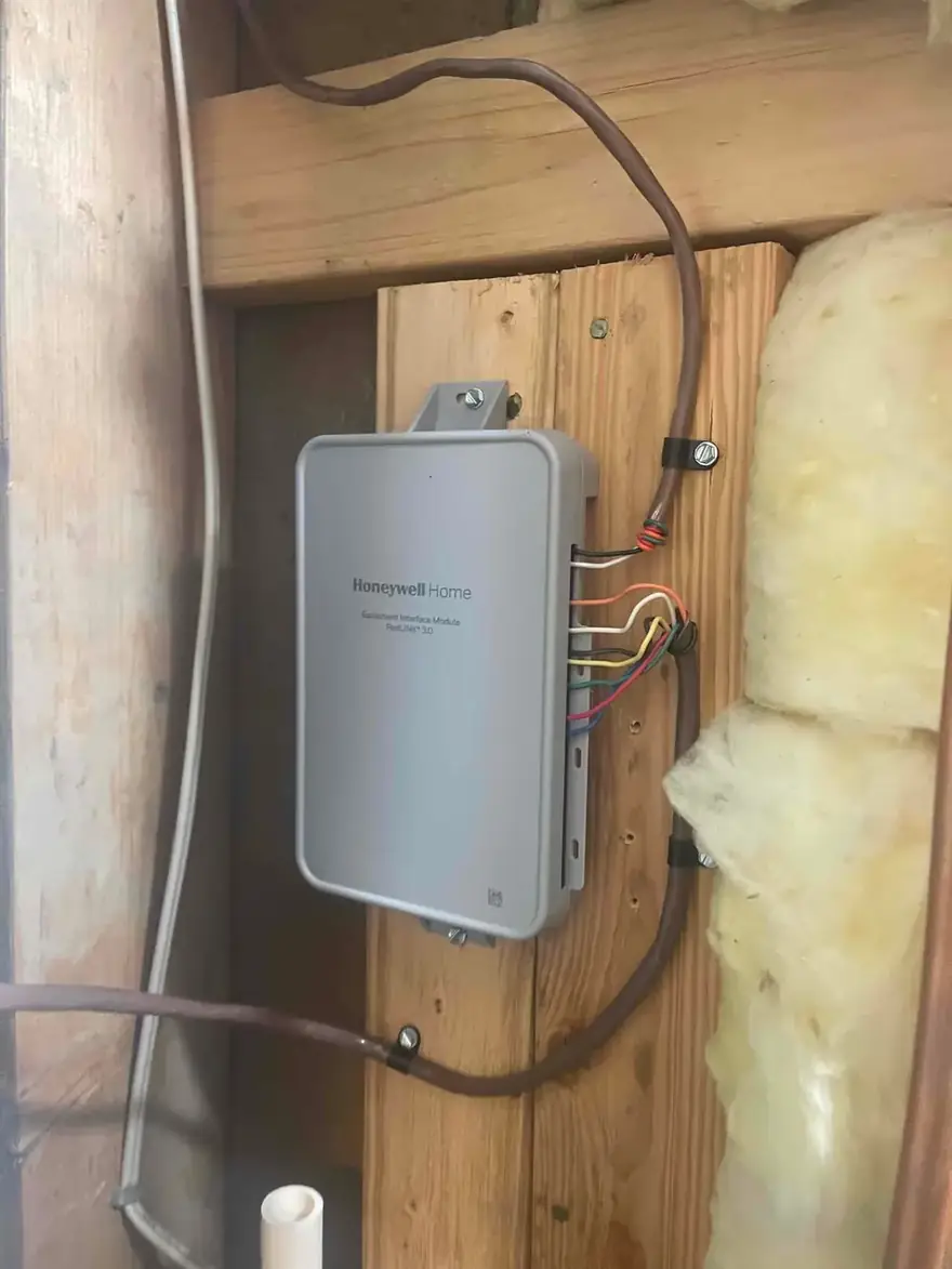 Thermostat control module wired to a basement wall stud
