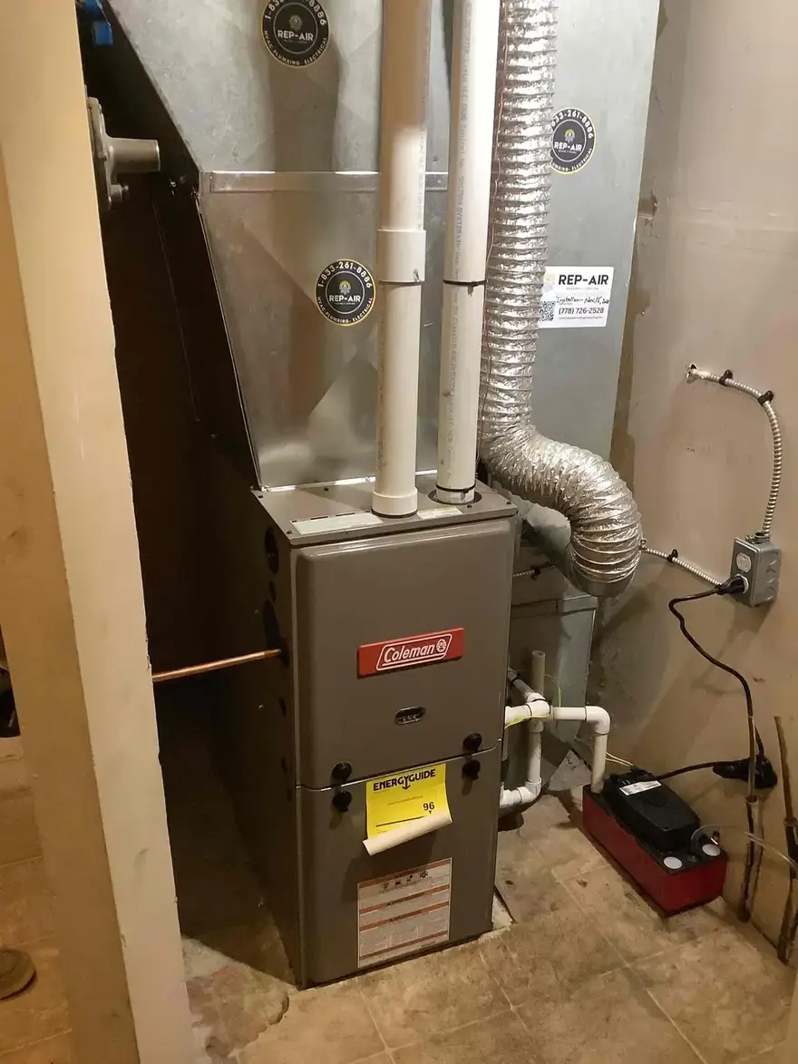 Coleman gas furnace with a condensate pump in a basement corner