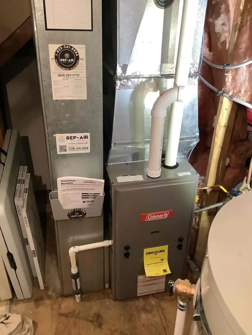 Coleman gas furnace with service tags in an unfinished basement
