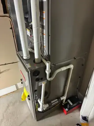 Close-up of furnace venting and condensate lines