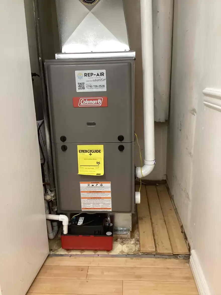 Coleman gas furnace with a Rep-Air sticker in a closet