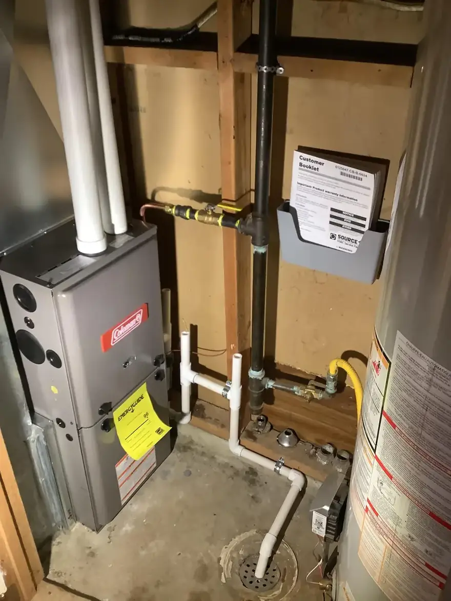 Coleman gas furnace with new gas piping in a basement corner