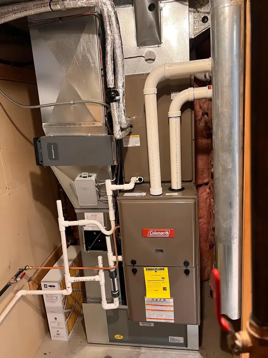 Coleman gas furnace with venting and ductwork in a basement