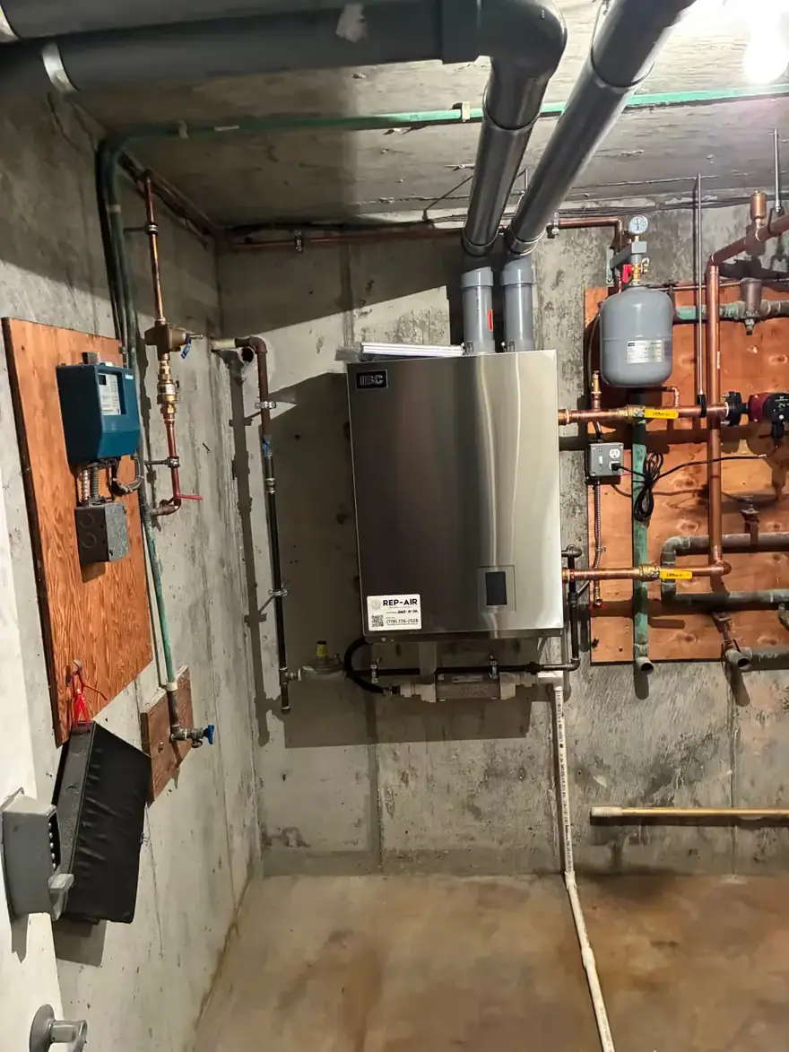 Wall-hung boiler with copper hydronic piping in a concrete basement