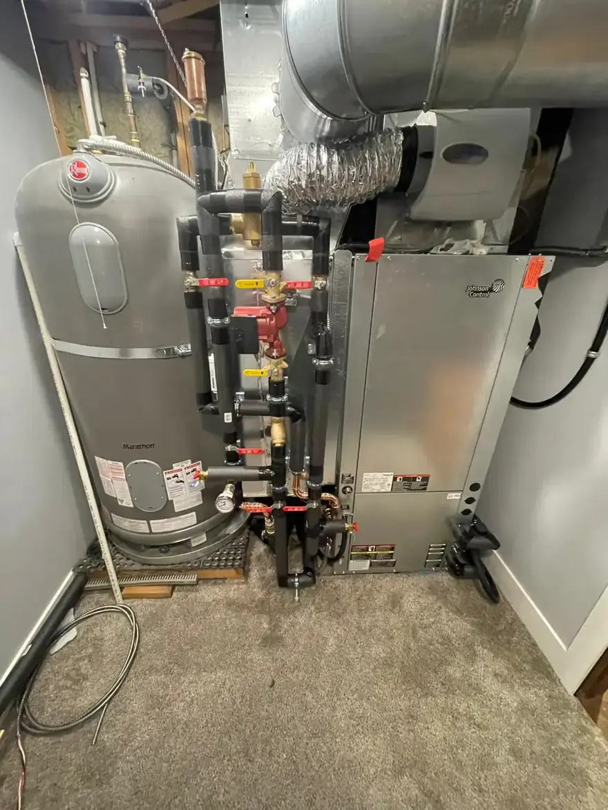 Boiler with hydronic piping and a storage tank in a utility room