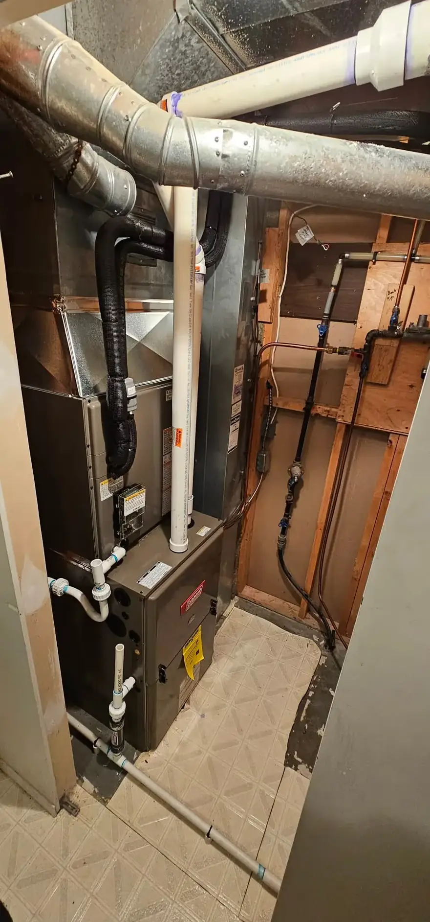 Gas furnace with venting in a tight utility space