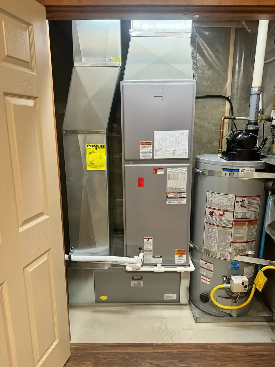 Air handler beside a gas water heater in a closet