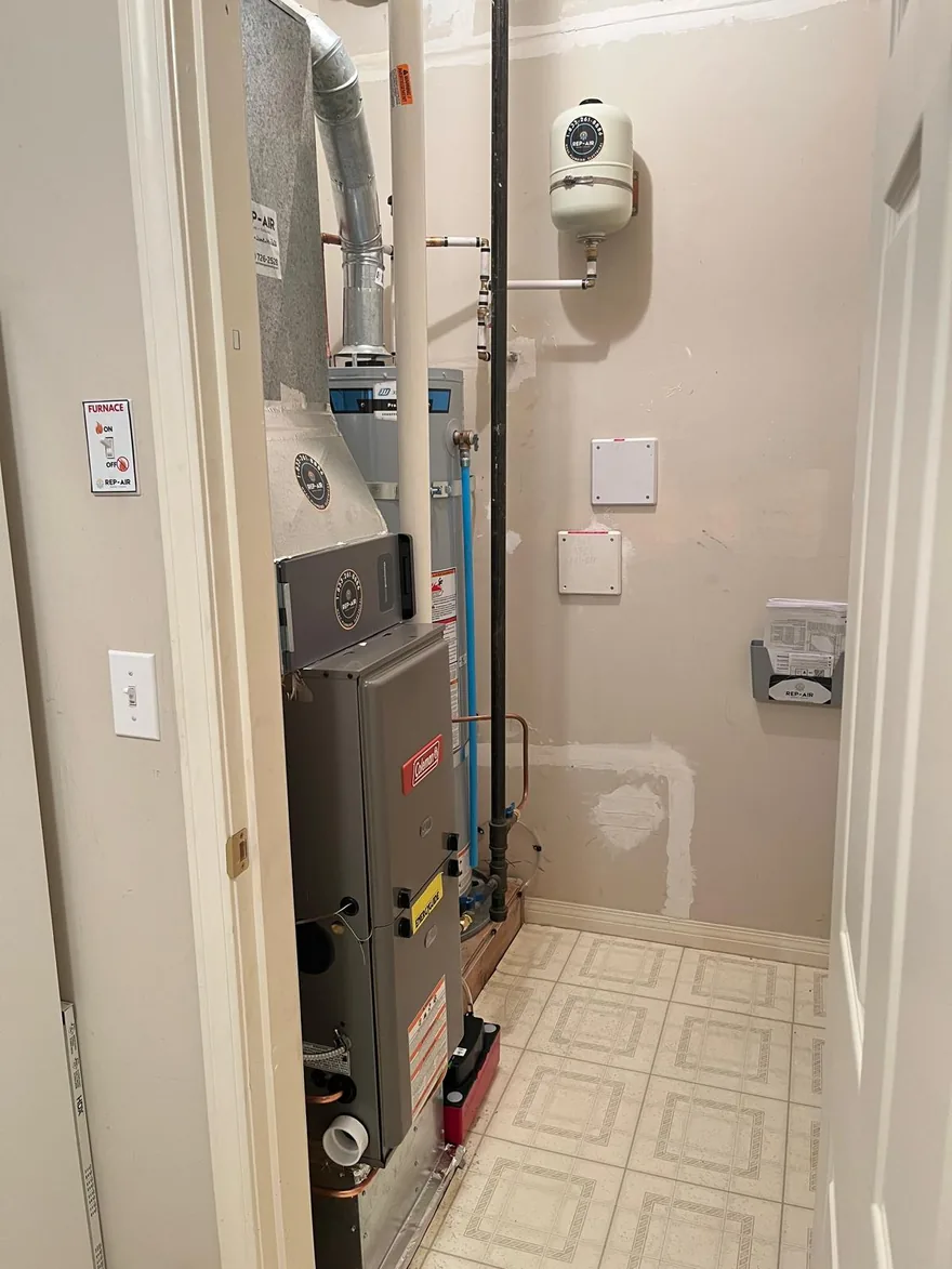 Gas furnace in a utility room with a tiled floor