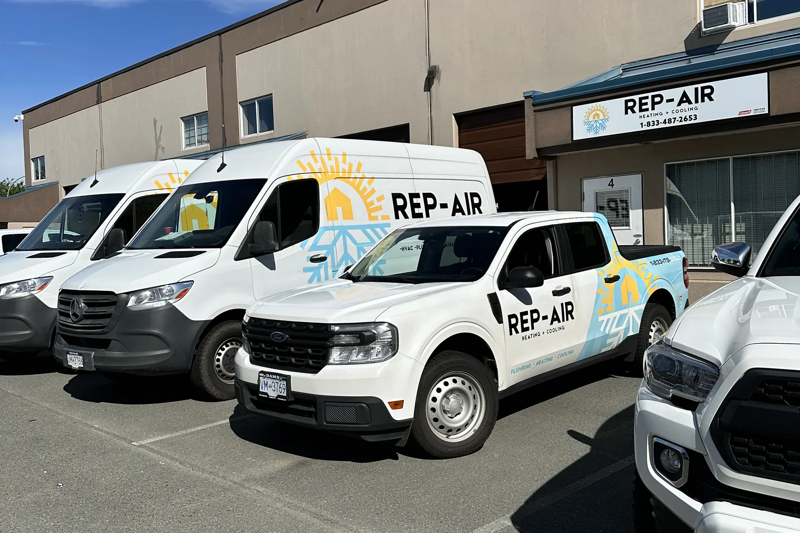 Rep-Air Heating and Cooling service vans and truck outside the shop in Mission, BC
